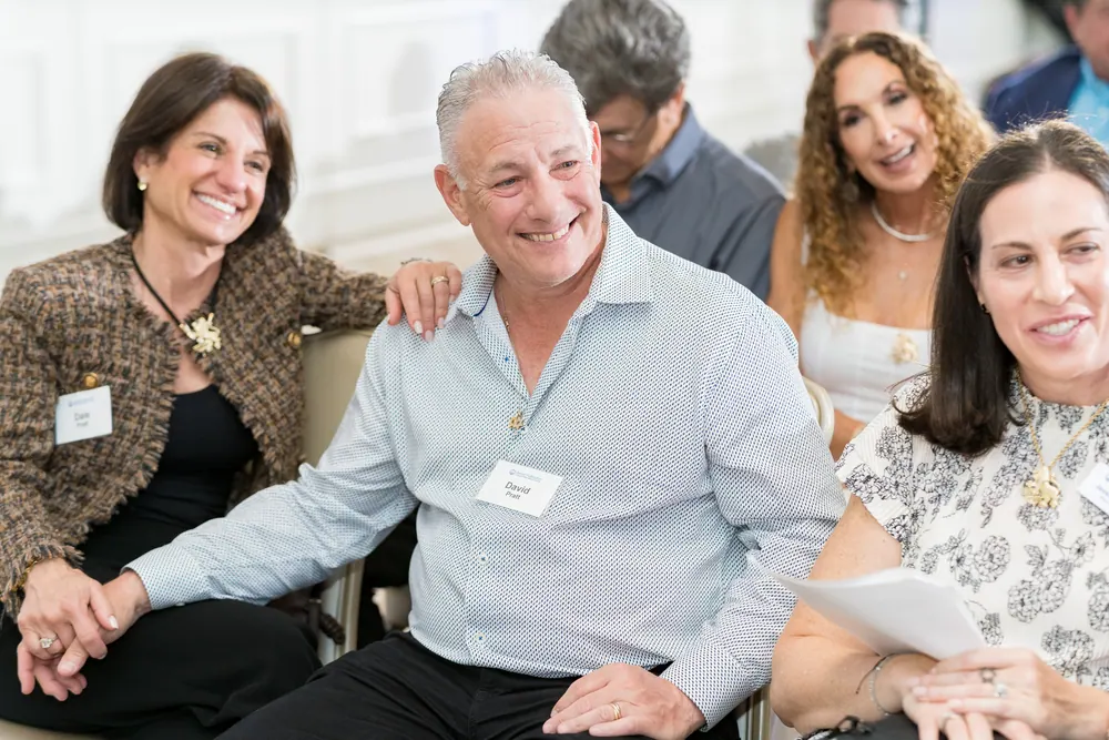 Smiling community members seated together at a Federation event